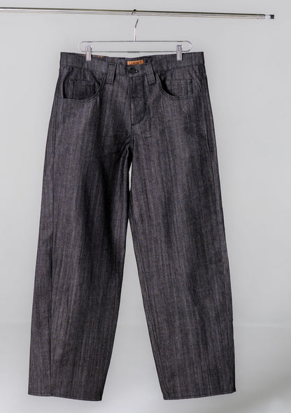 Dark denim jeans hanging on a white background
