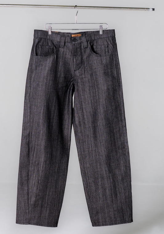 Dark denim jeans hanging on a white background