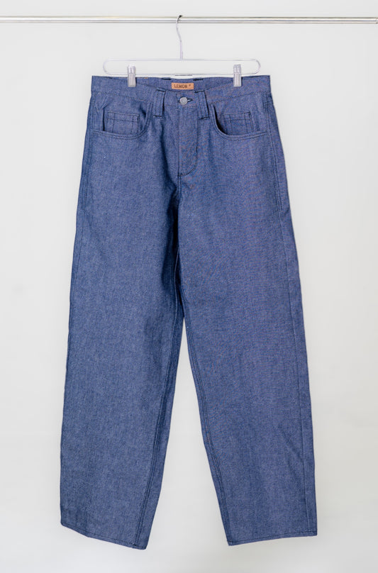 Blue jeans hanging on a white background