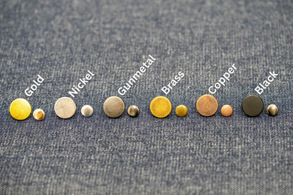 Set of metallic buttons labeled with their names on a denim background